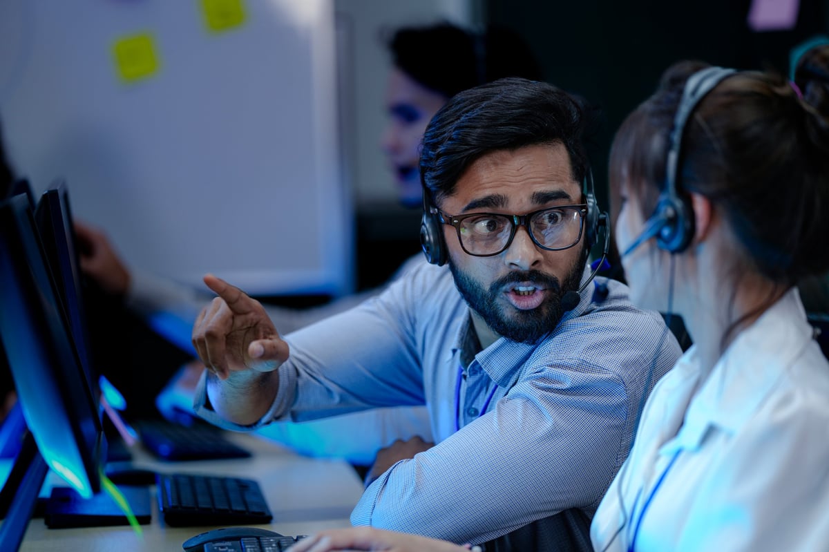 Call center agents collaborating on complex IT support cases, demonstrating teamwork and expertise