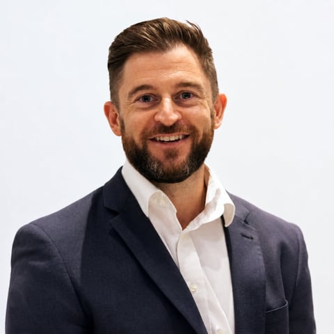 Headshot of Mark Harding, Managing Director of Contrac, with dark hair and beard wearing a navy blazer and white dress shirt